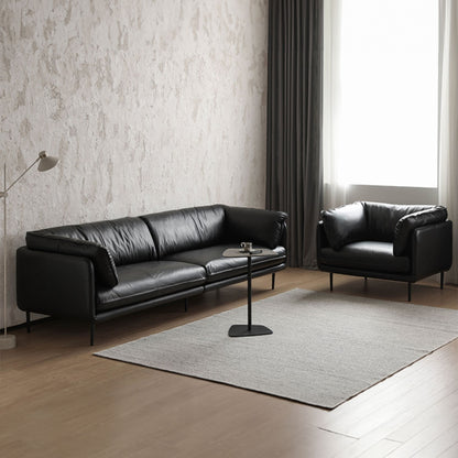 Cuddle black leather sofa and armchair shown in a photoshoot