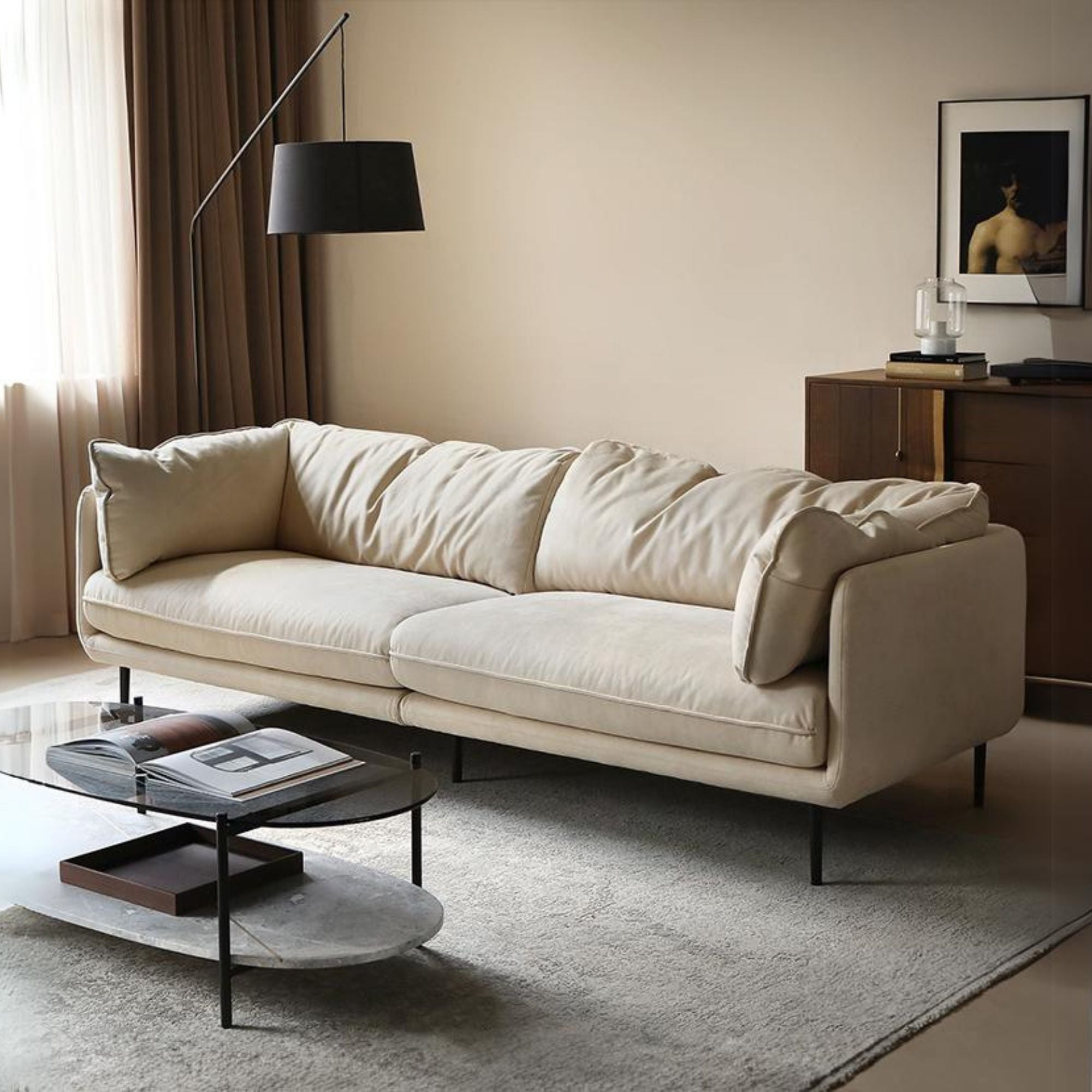 White sofa in a living room with a coffee table and lamp.