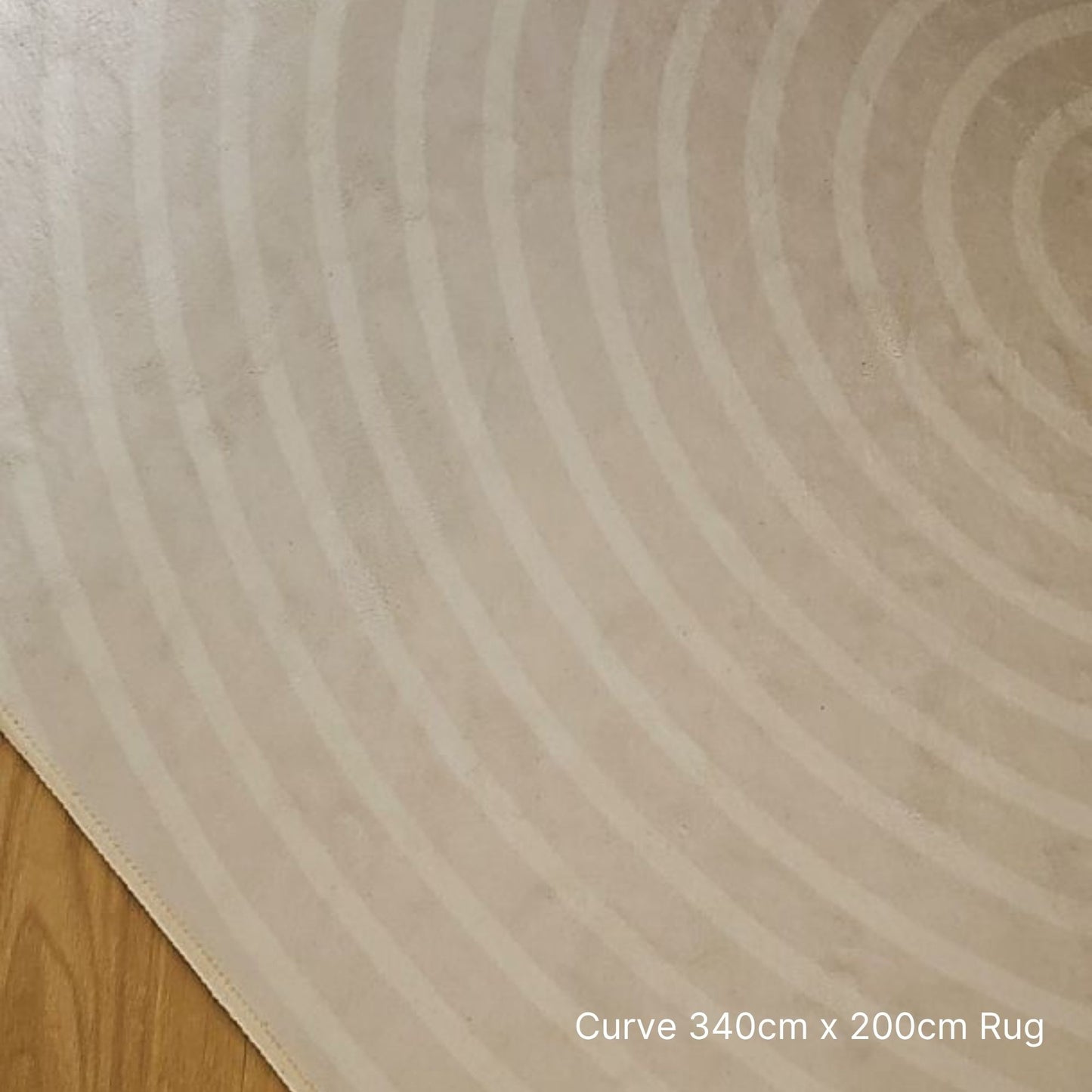 Beige rug with circular pattern on a wooden floor