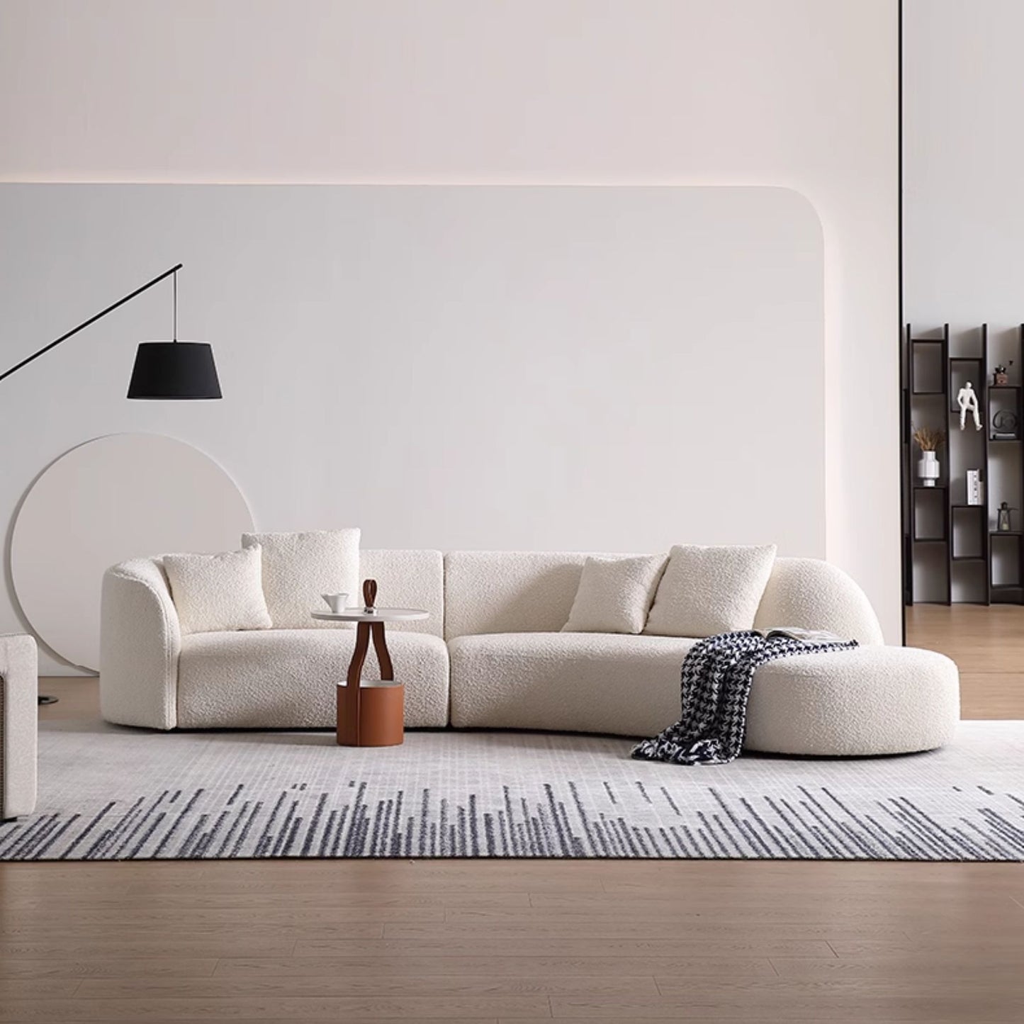 Modern living room with a white sofa, coffee table, and decorative items.