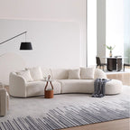 Modern living room with a white sofa, coffee table, and decorative items.