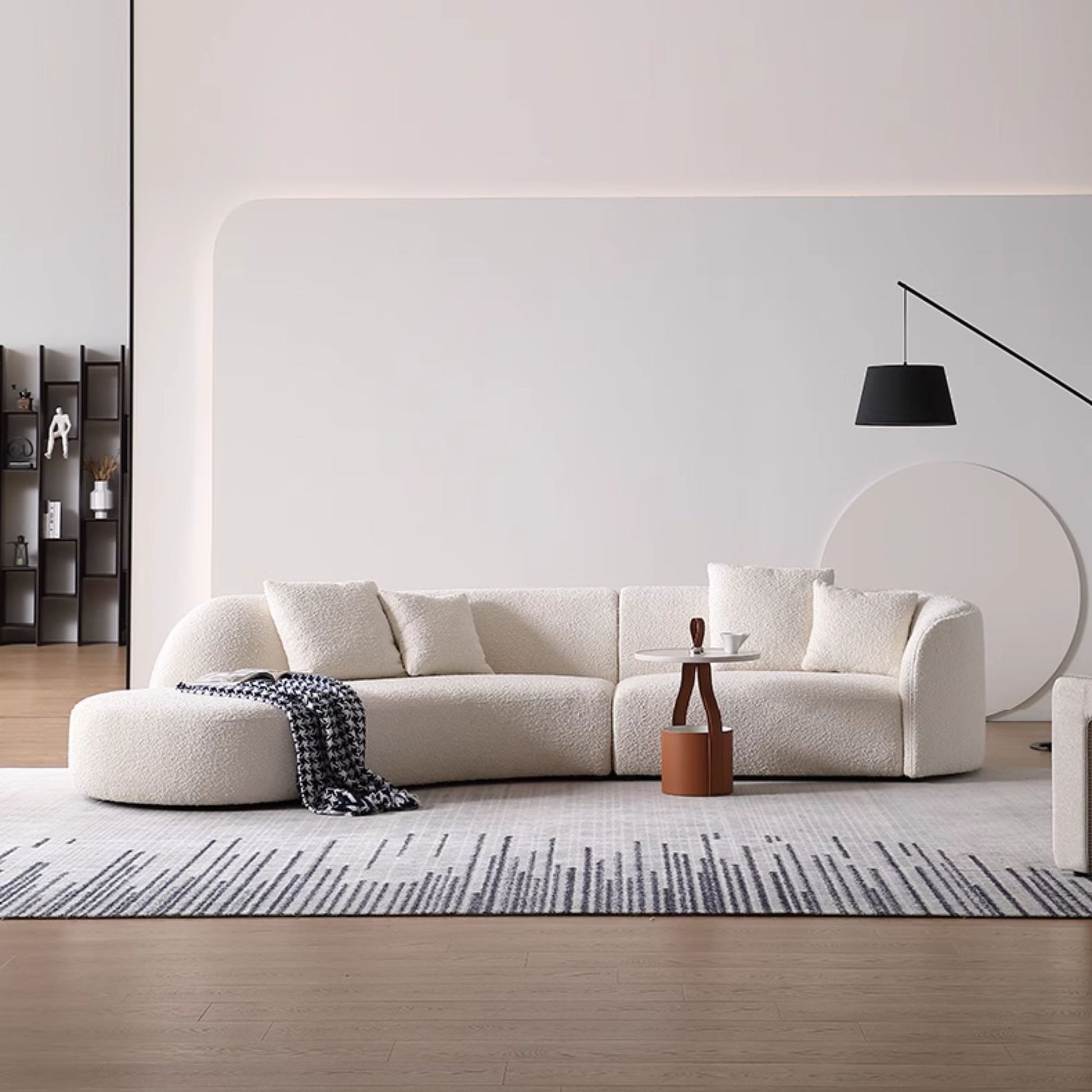 Modern living room with a white sofa, coffee table, and decorative items.