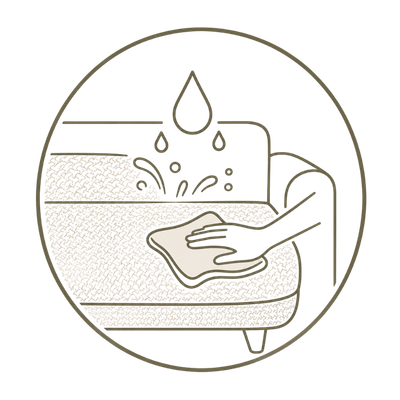A minimalist line-art icon depicting a hand wiping a sofa with a cloth, with water droplets above, inside a circular border on a white background.