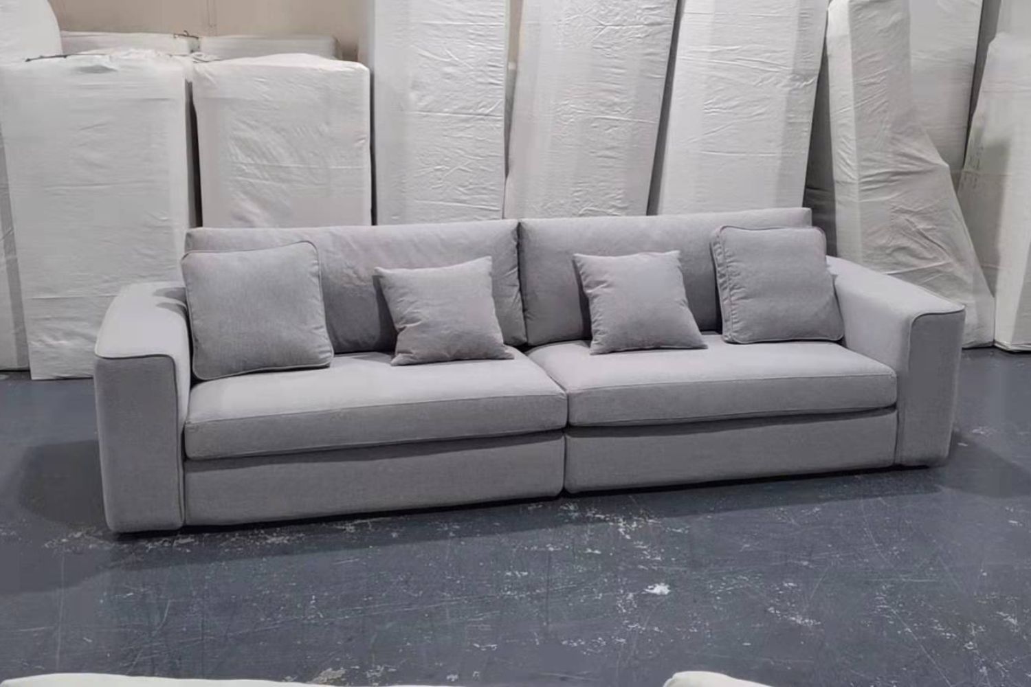 Coastal 260cm grey fabric sofa on factory floor