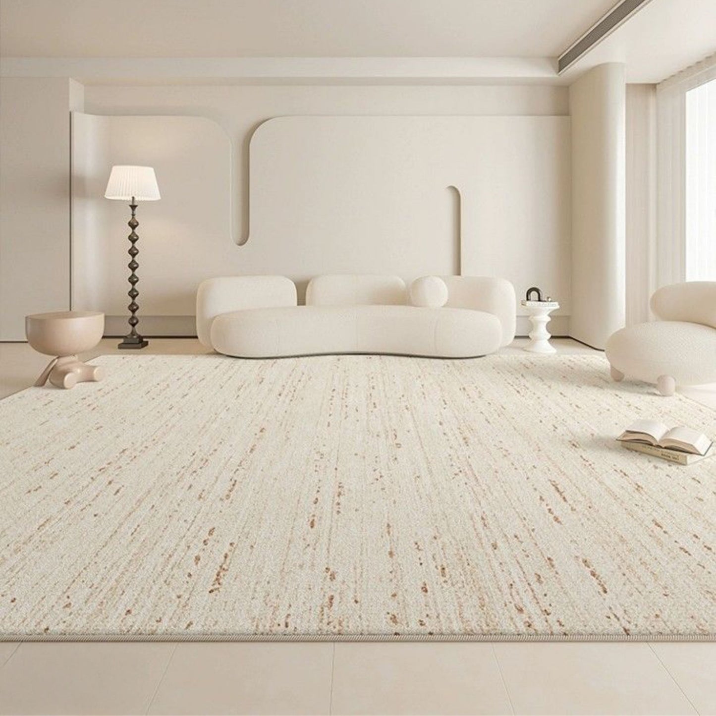Modern living room with a textured white rug, white sofa, and minimal decor.