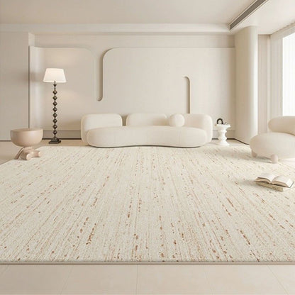 Modern living room with a textured white rug, white sofa, and minimal decor.