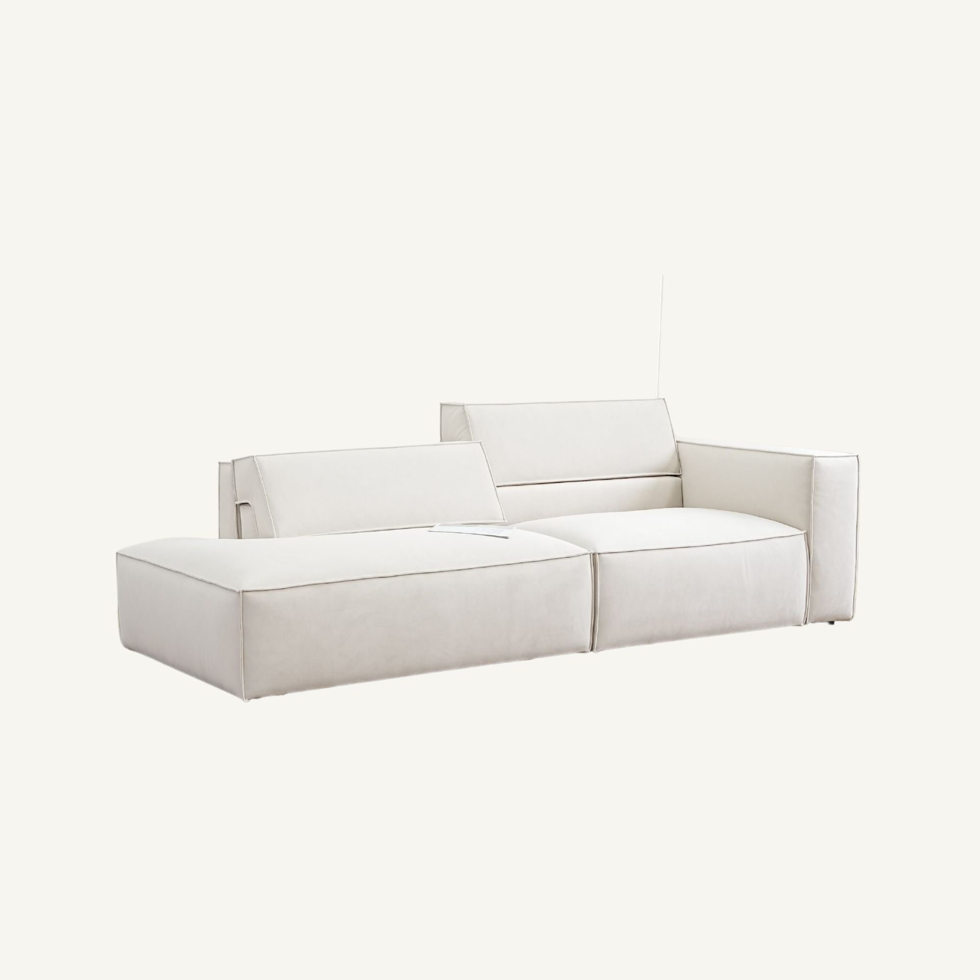 A modern modular sectional sofa upholstered in off-white fabric, featuring one armrest, two seat cushions, and a backrest, shown against a solid off-white background.