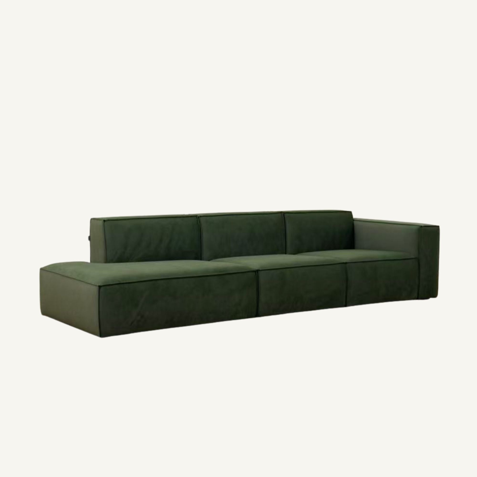 A modern three-seater sofa upholstered in dark forest green velvet, shown from a three-quarters angle against a plain off-white background.
