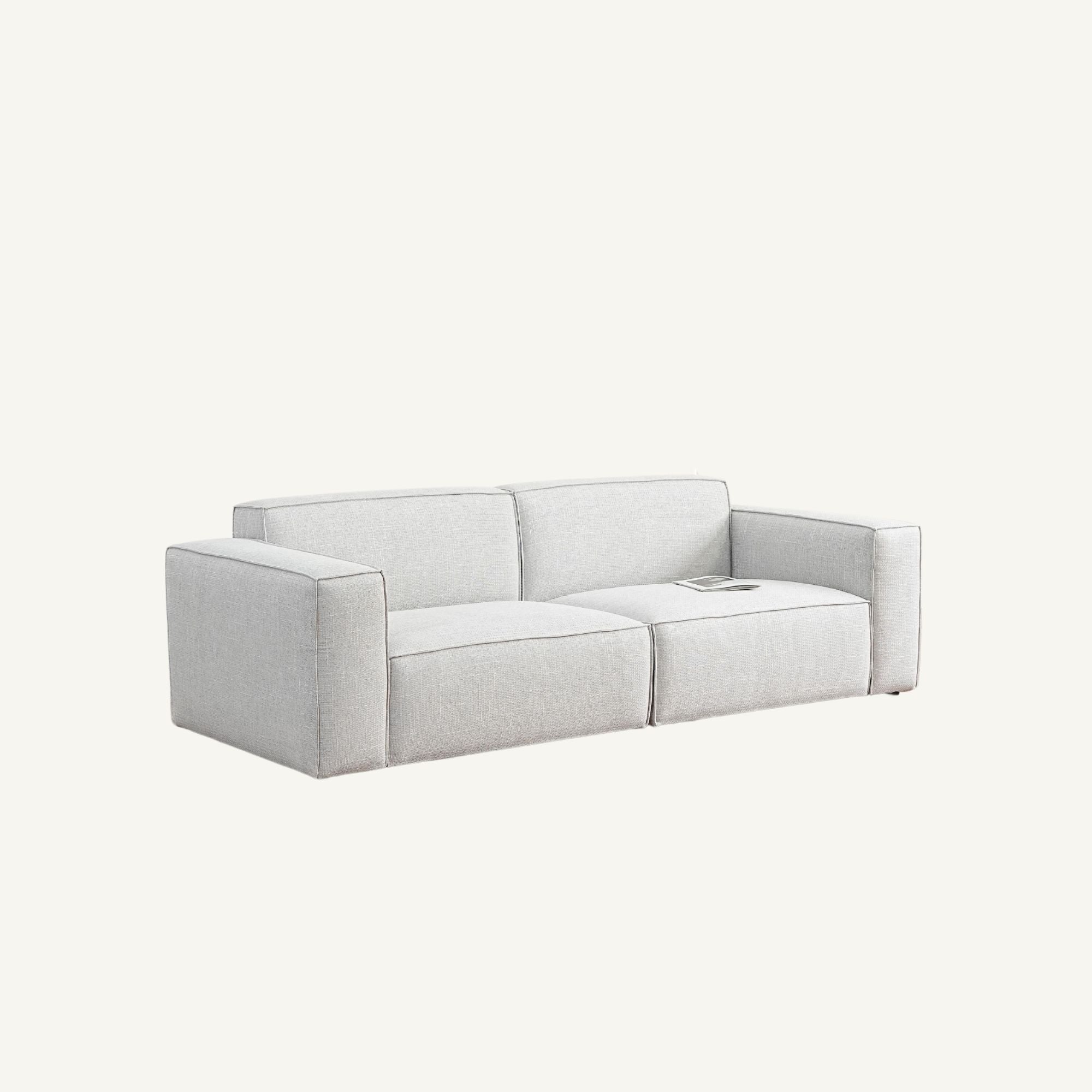 A modern two-seater sofa upholstered in a light gray textured fabric, shown from a three-quarters angle against a solid off-white background.