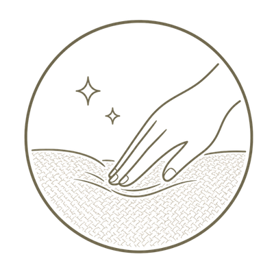 A minimalist line-art icon depicting a hand pressing down into a textured, quilted surface inside a circular border, with small sparkle marks above. The design is rendered in a warm taupe-brown color on a solid white background.