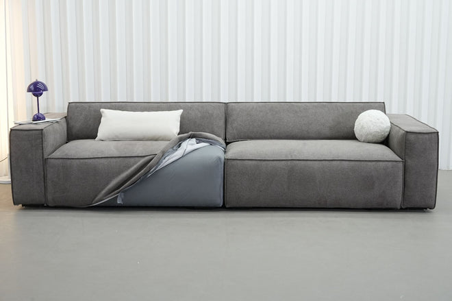 Showing how Cubix adjustable backrest sofa has removable covers with one part of the seat cushion covers partially removed