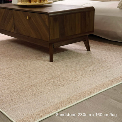 Beige rug on a wooden floor with a coffee table in the background