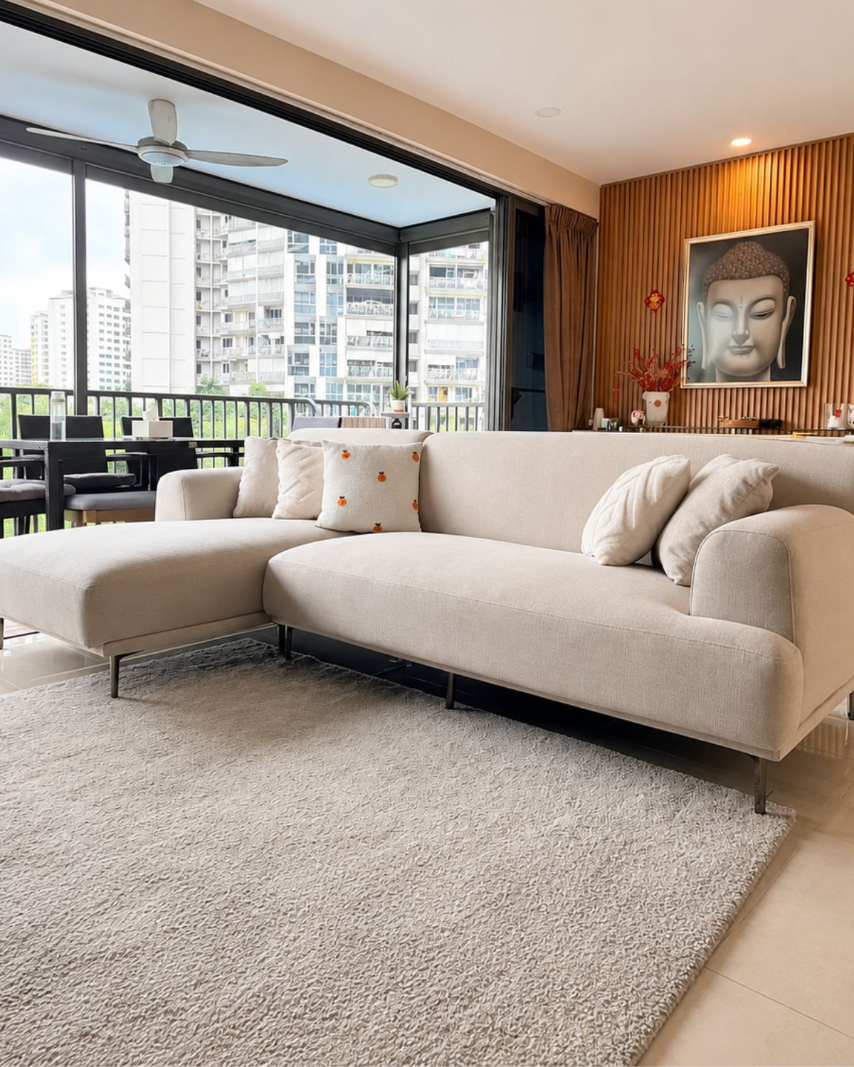 Grey sectional sofa in a modern living room with decorative pillows.