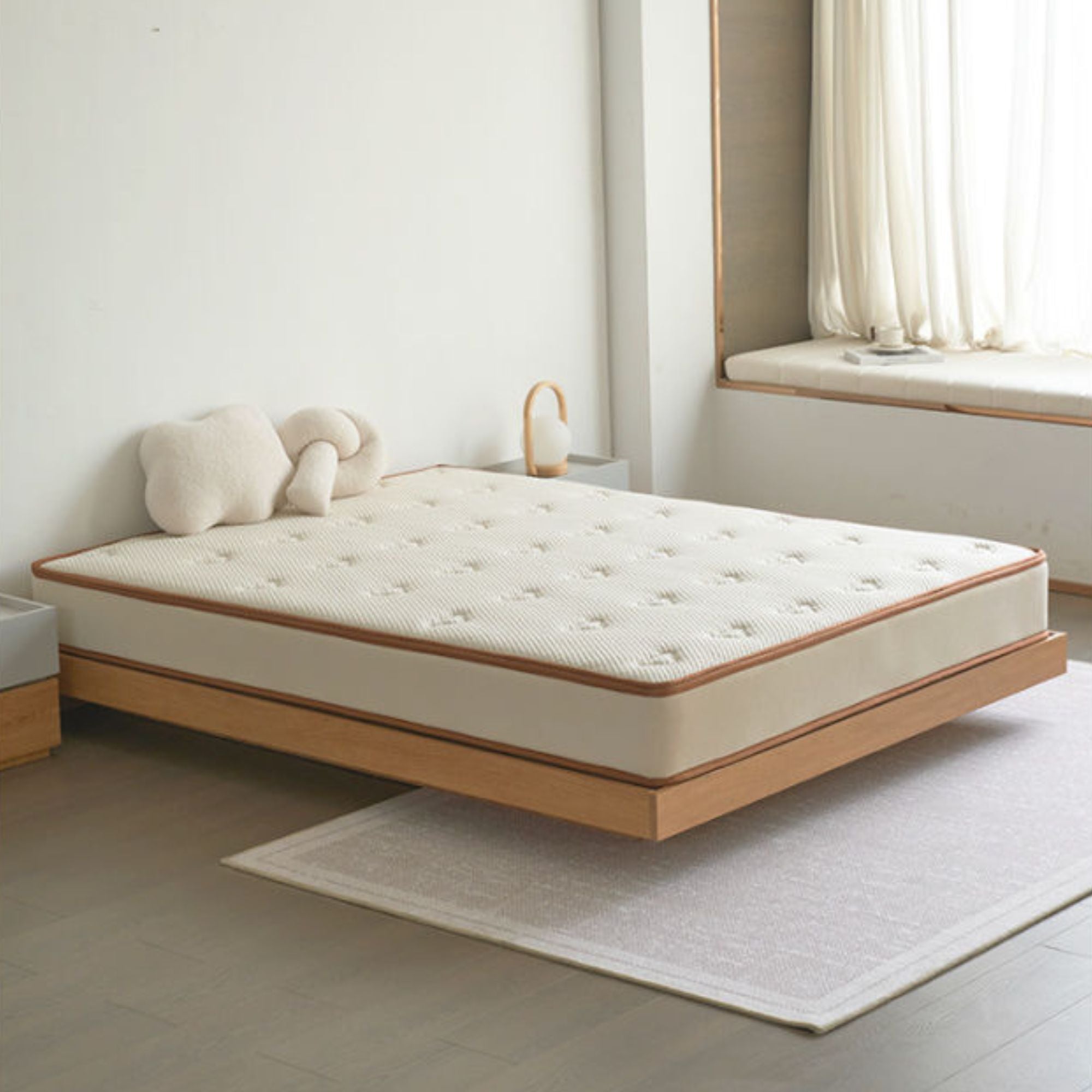 Mattress on a wooden bed frame in a minimalistic room with a window and rug.