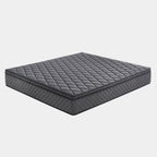 A dark gray quilted mattress shown at an angle on a light gray background.