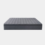 A dark gray quilted mattress shown from a high angle against a light gray background.