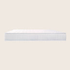 White mattress on a light beige background