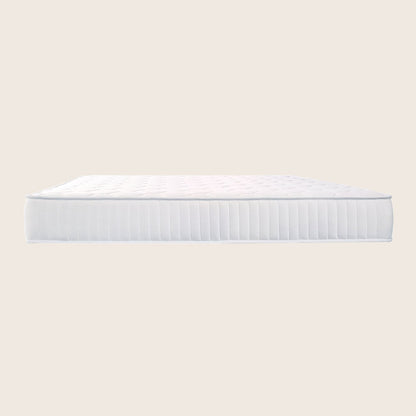White mattress on a light beige background