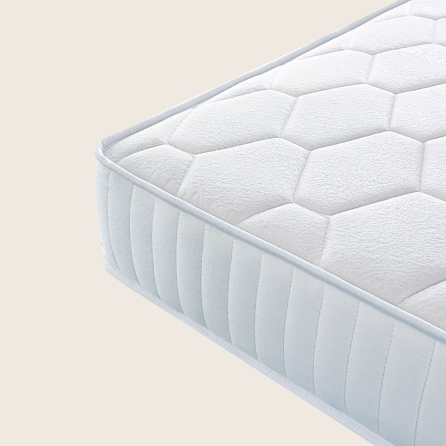 White quilted mattress on a beige background
