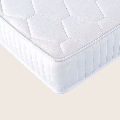 White quilted mattress on a beige background