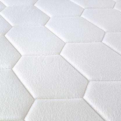 Close-up of white hexagonal tiles arranged in a pattern which is the top cover pattern for Stellar mattress
