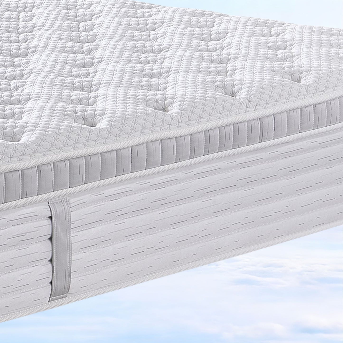 Close-up of a mattress with a textured surface on a light blue background