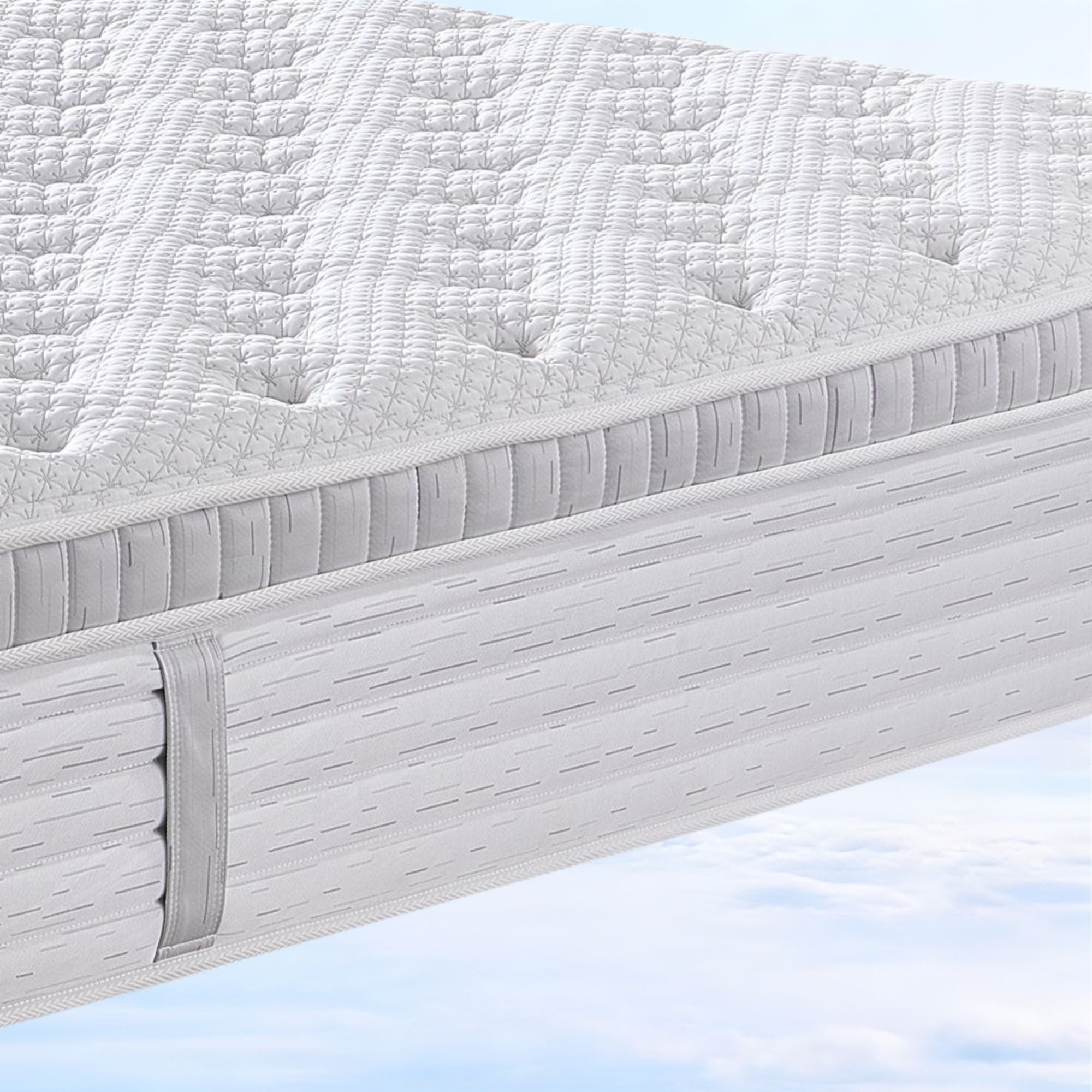 Close-up of a mattress with a textured surface on a light blue background