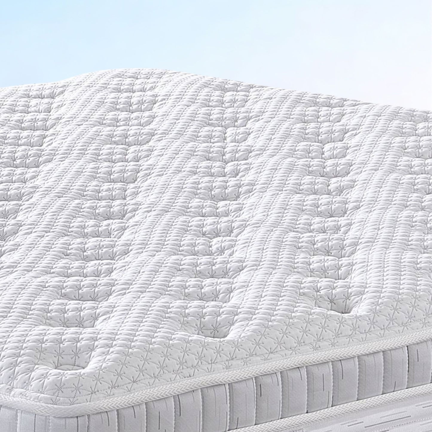 White quilted mattress with a light blue background