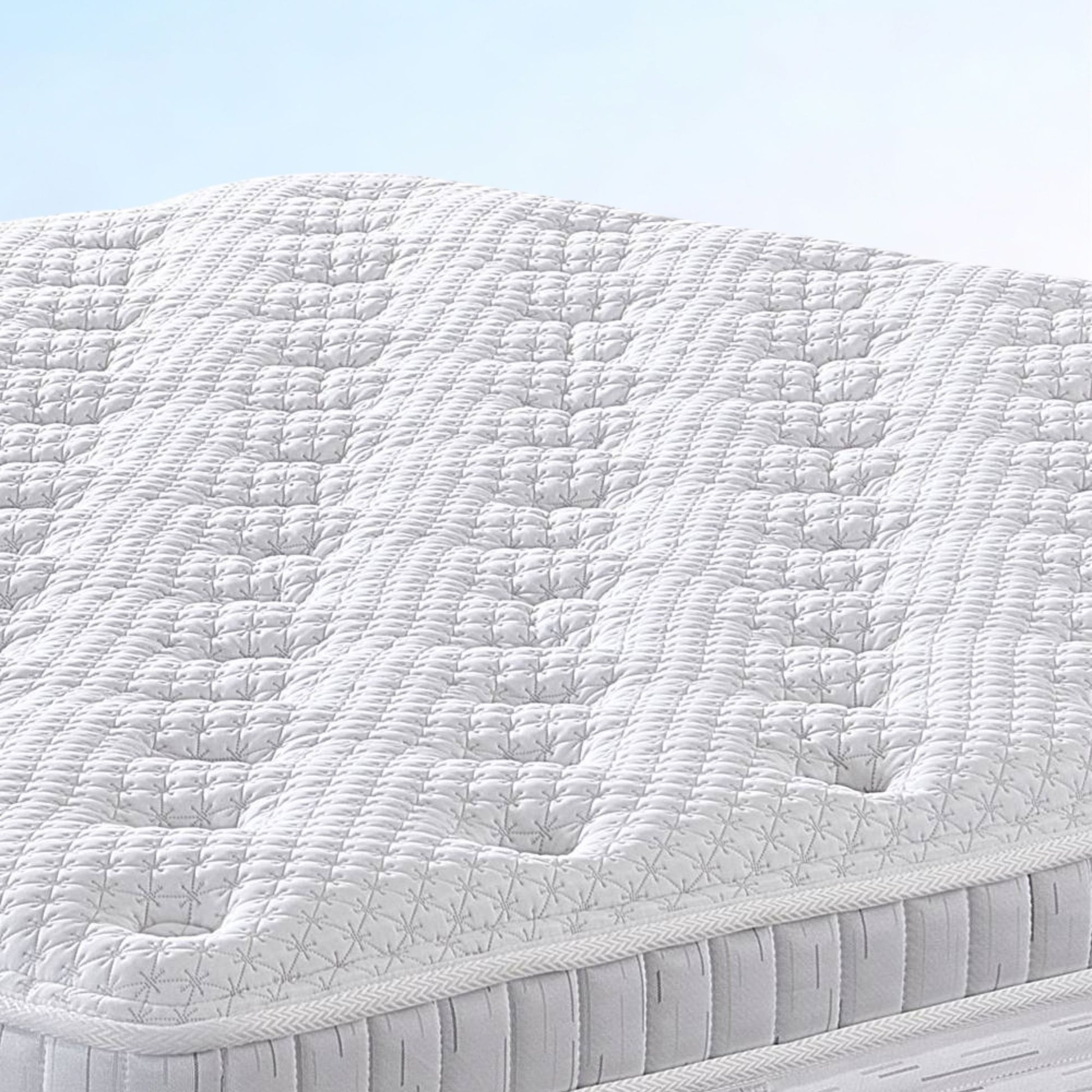 White quilted mattress with a light blue background