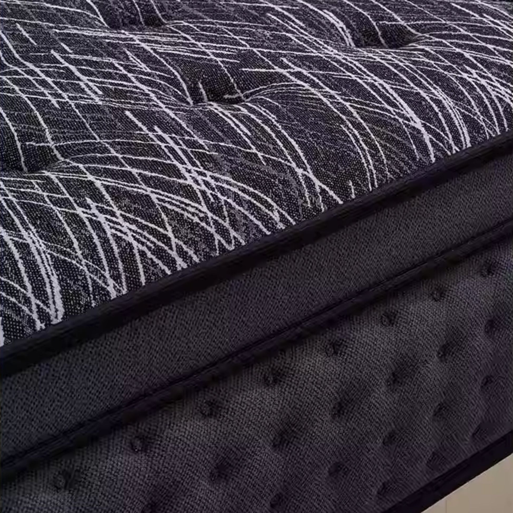 Close-up of a mattress with a textured surface and patterned cover.