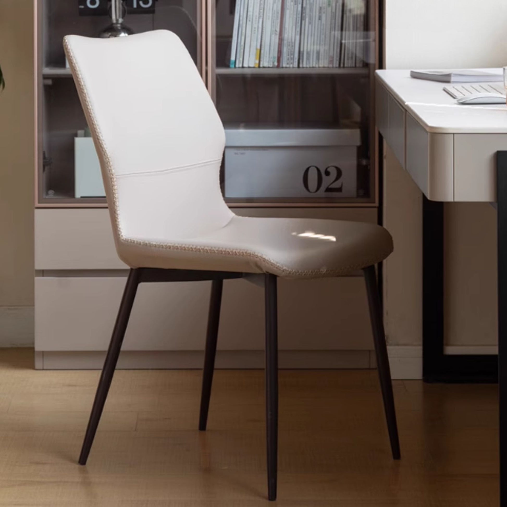 Grey chair with black legs in a room setting