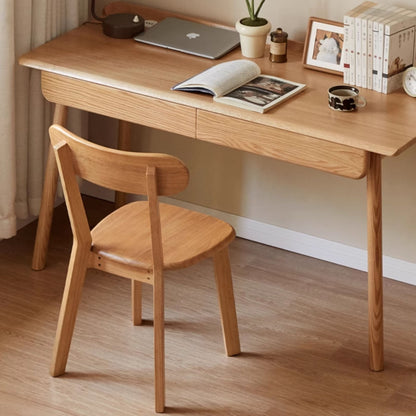 Wooden desk with chair, laptop, and books in a home office setting.