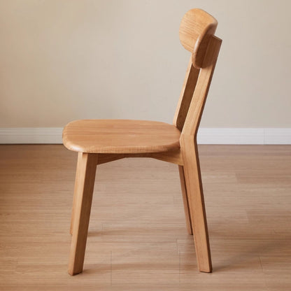 Wooden chair on a wooden floor with a beige wall background