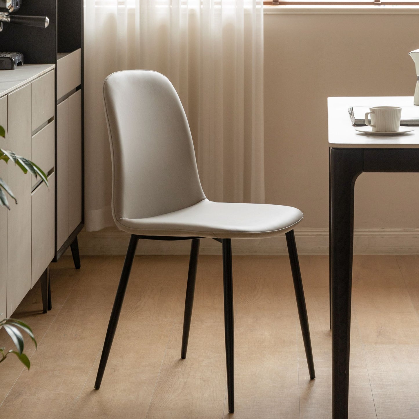 Grey chair with black legs in a modern kitchen setting