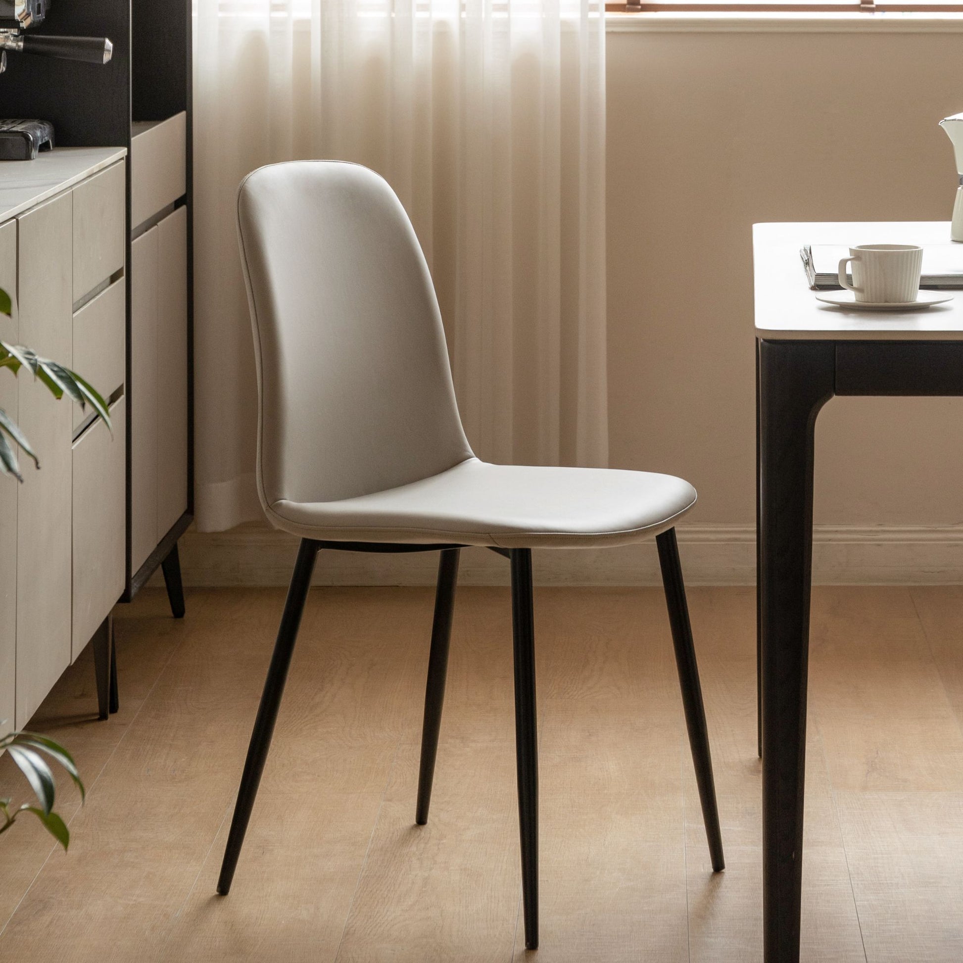 Grey chair with black legs in a modern kitchen setting