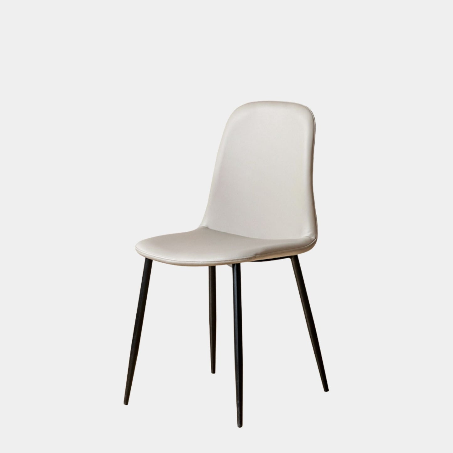 Grey chair with black legs on a light gray background