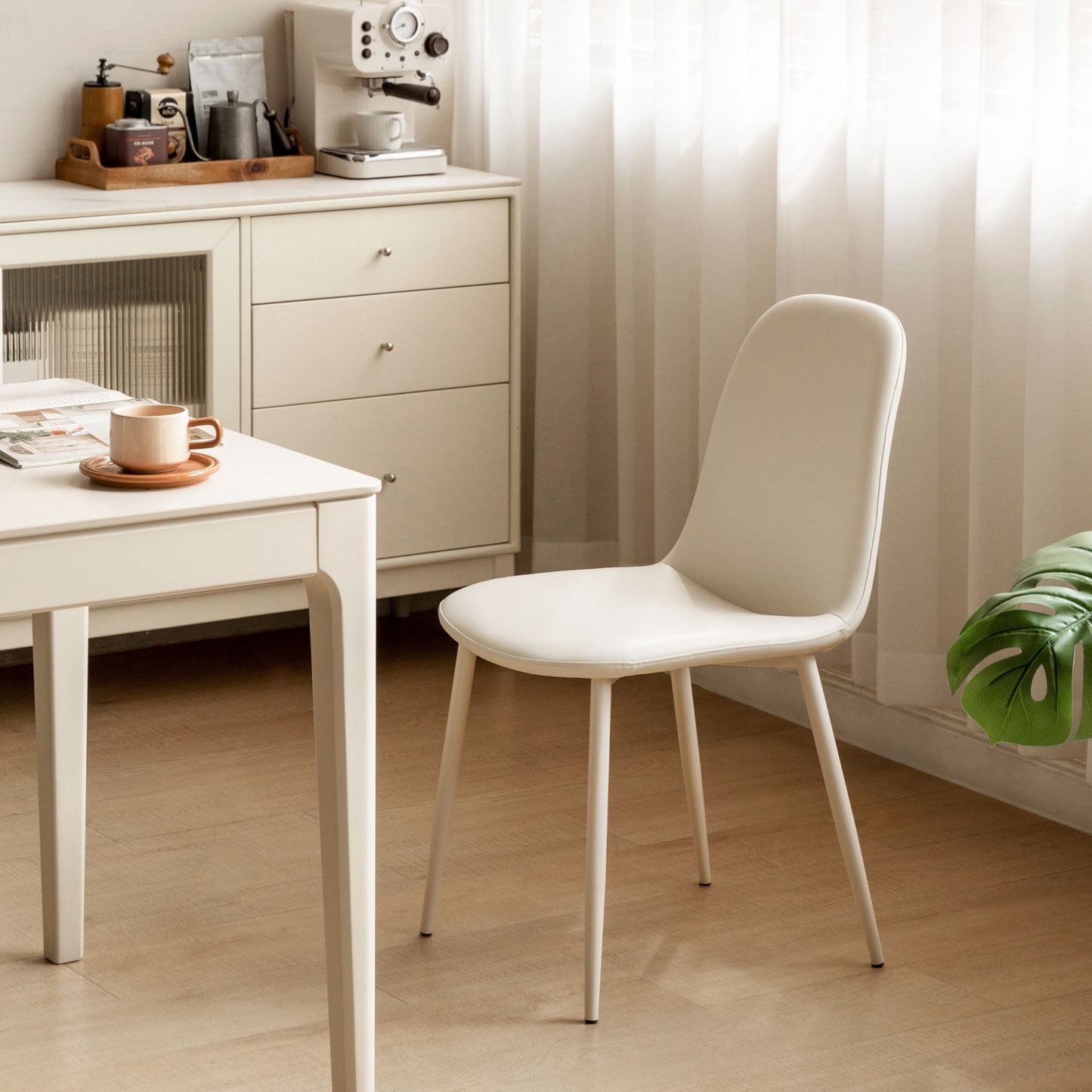 White chair in a room with a desk and cabinets.