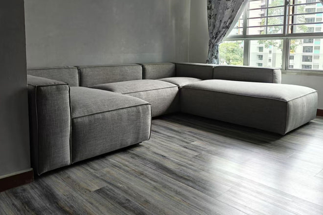 Cubix U-shaped modular sofa with the opening between the two extending sides in black fabric in living room