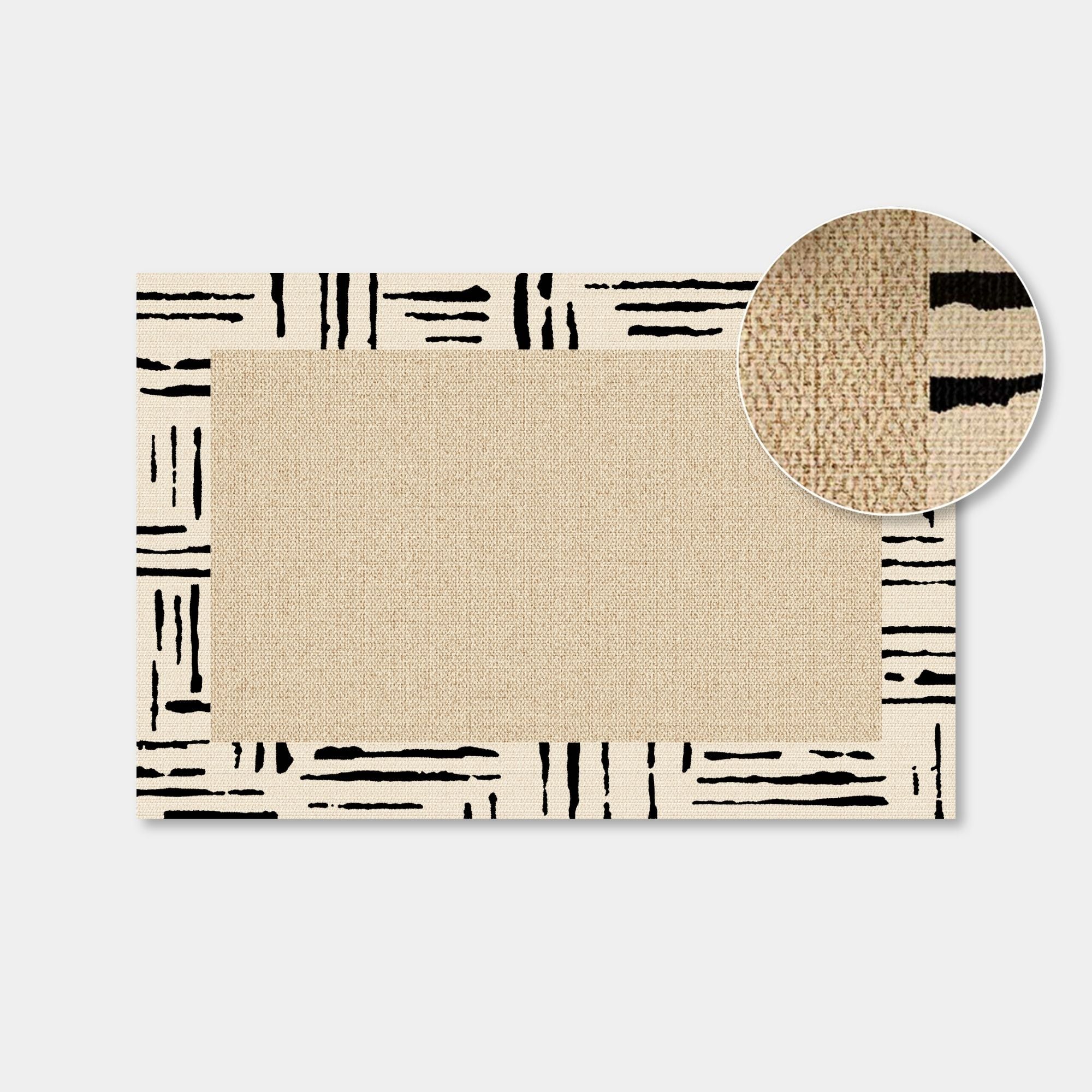 A rectangular woven rug with a beige center and a cream border featuring black abstract brushstroke patterns, shown on a light gray background with a circular inset highlighting the woven texture.